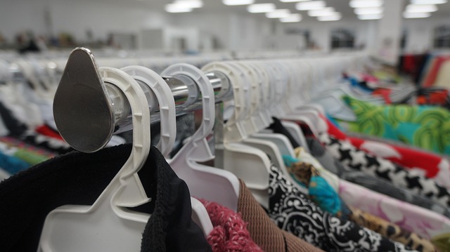 minimalist fashion retail display with neutral tones and clothing racks educational context